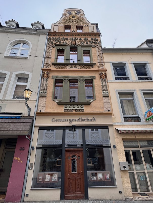 A narrow house with an ornate painted facade stands in the old town of Trier.