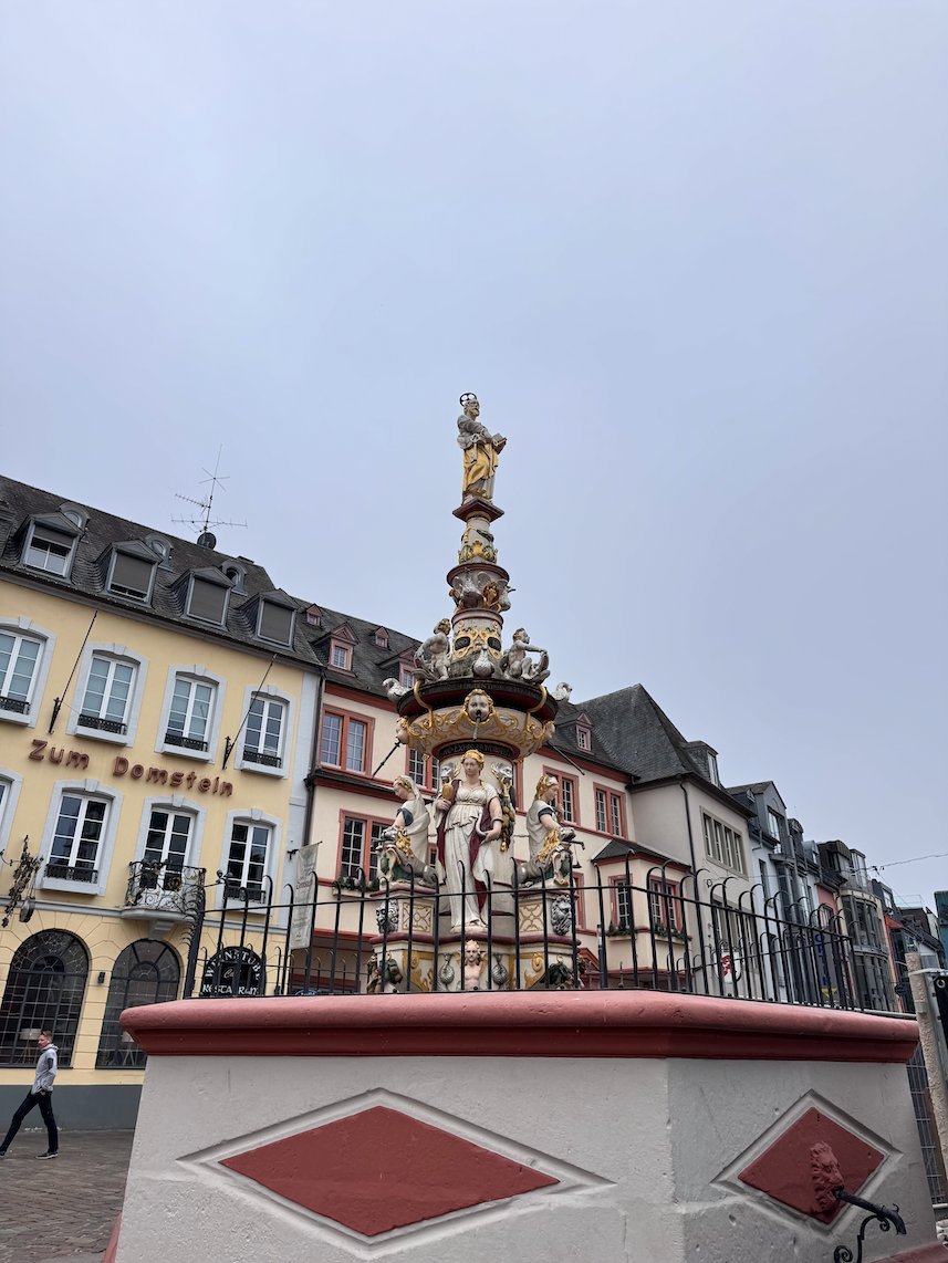 The colorful St. Peter's Fountain stands on the Hauptmarkt in Trier.