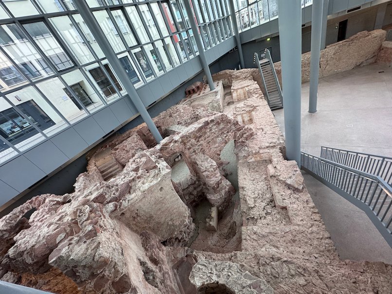 Roman bath ruins lie under a glass roof at the Viehmarkt in Trier.