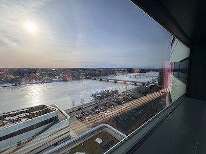 View from a high hotel window over the frozen Ume River, a bridge and a parking area