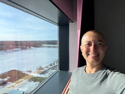 Selfie by a high hotel window with a view over the frozen Ume River