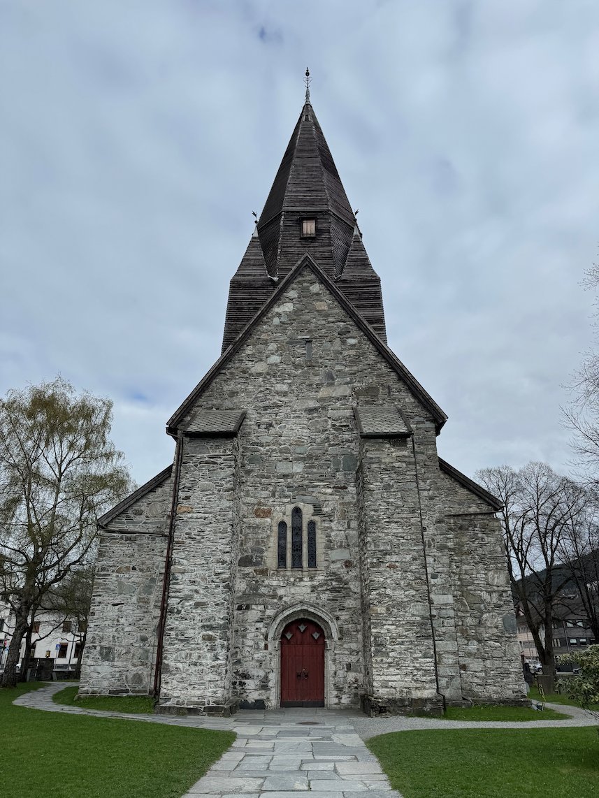 Vangskyrkja, the medieval stone church in Voss, under a grey sky