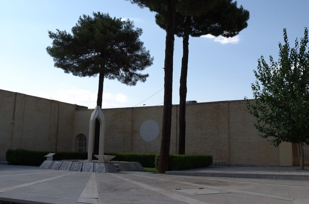 Courtyard with pine trees and a memorial at Vank Cathedral