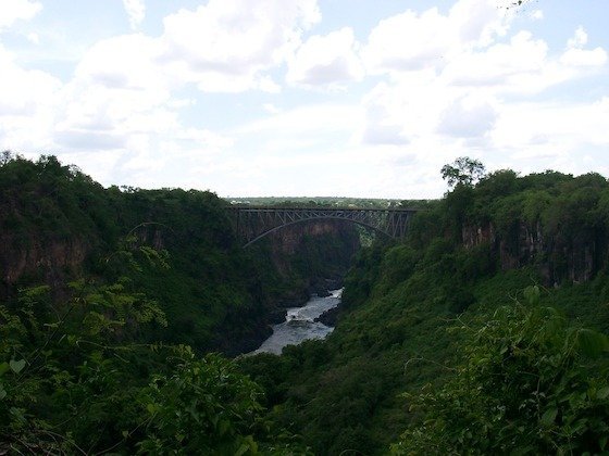The Victoria Falls Bridge spans the green Zambezi gorge below Victoria Falls.