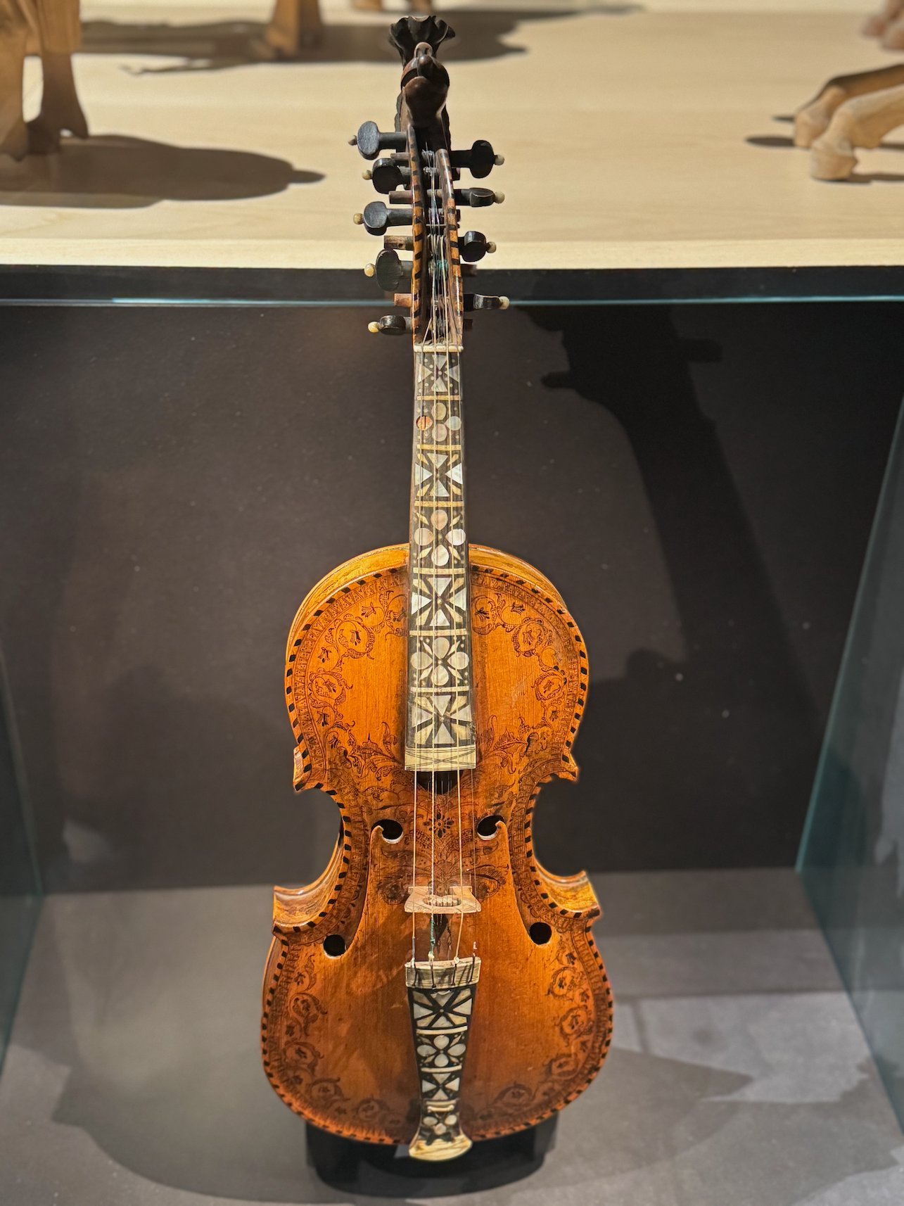 Hardanger fiddle with inlaid decoration in a glass case at Voss Folkemuseum