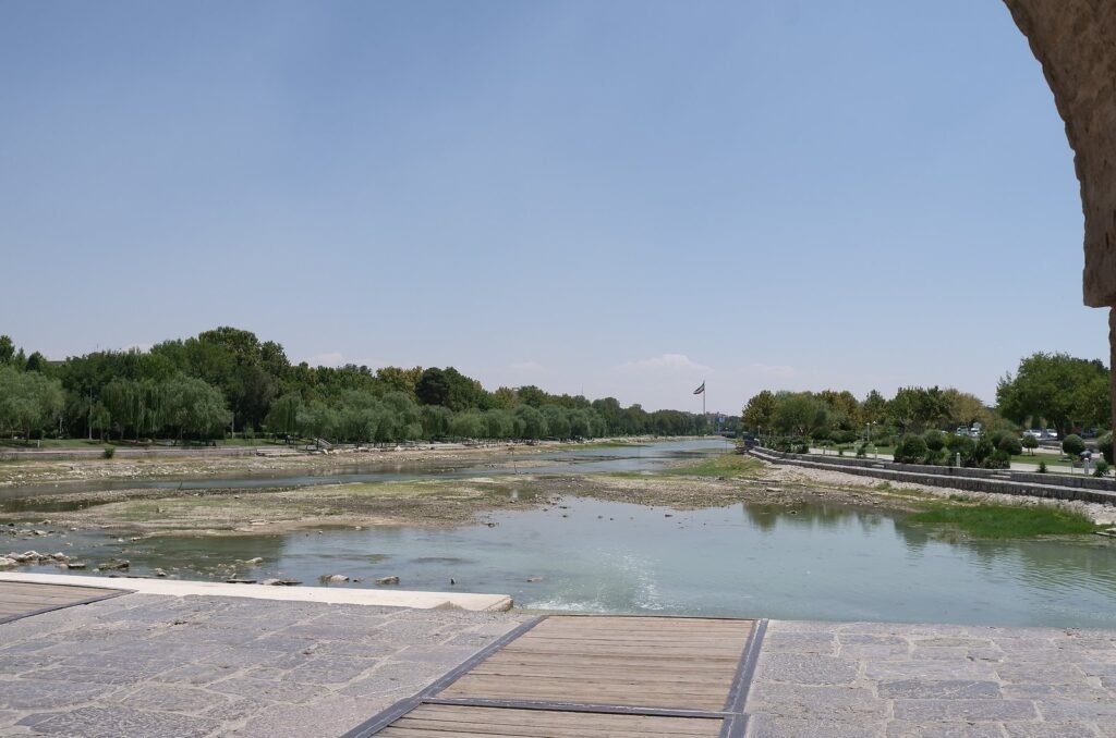 Zayandeh River and trees seen from a historic bridge