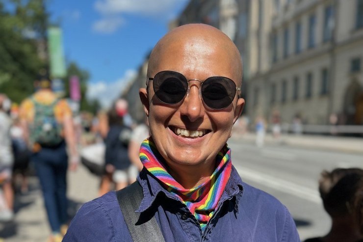 Zayera Khan walks through Stockholm wearing a rainbow scarf while leading a Pride-themed tour, photographed by Zayera Khan