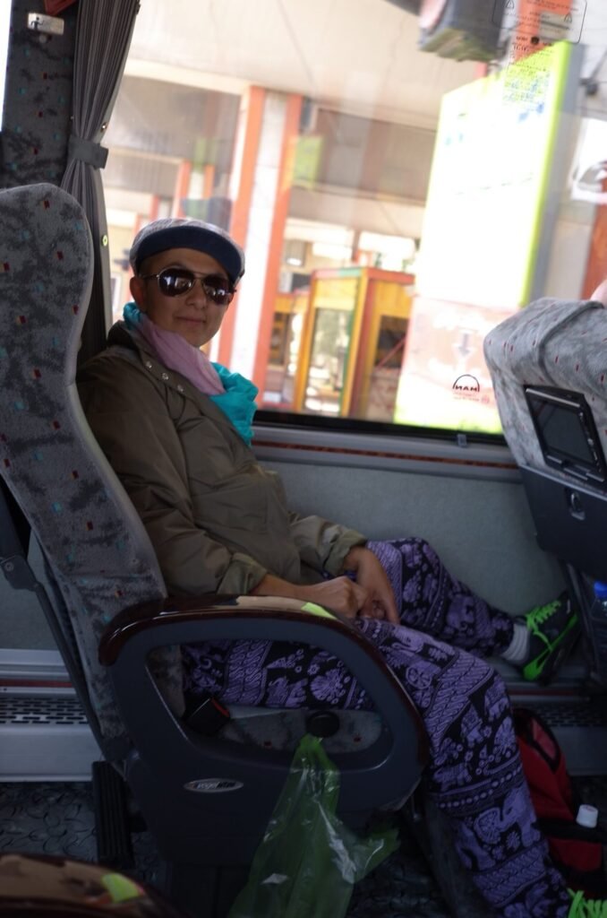 Zayera Khan in sunglasses and a cap on the tour bus in Iran