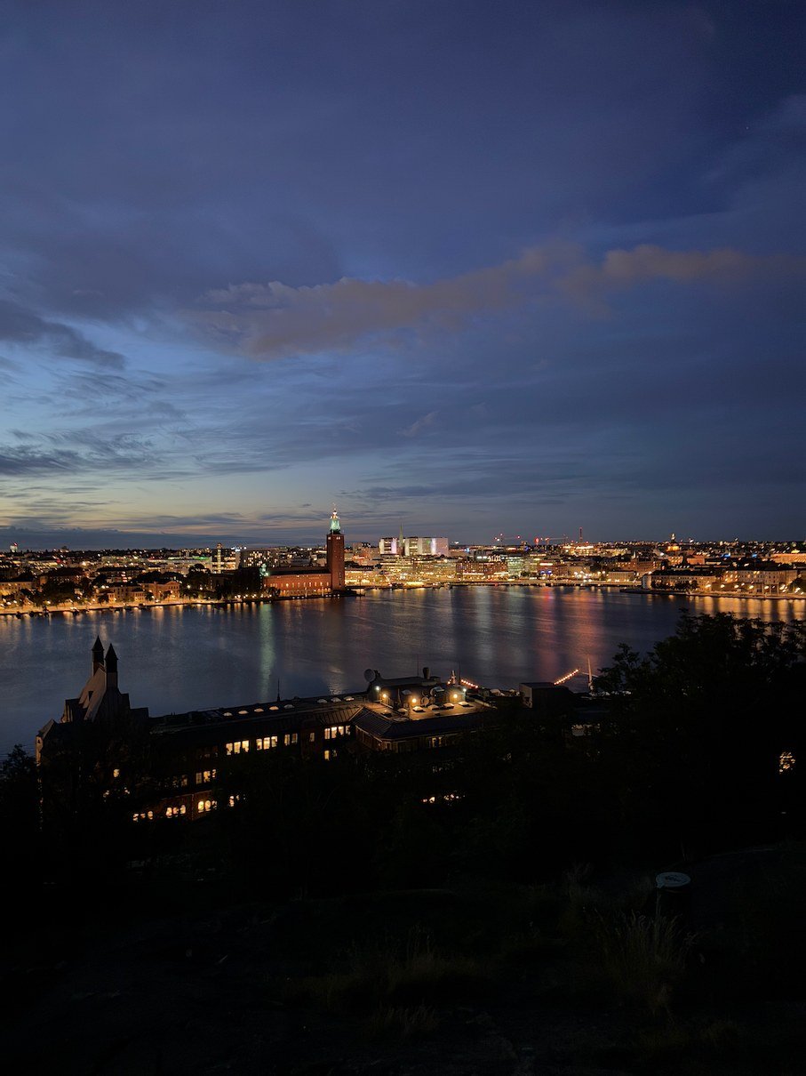 Stockholm's city lights reflected over the water at night, photographed by Zayera Khan