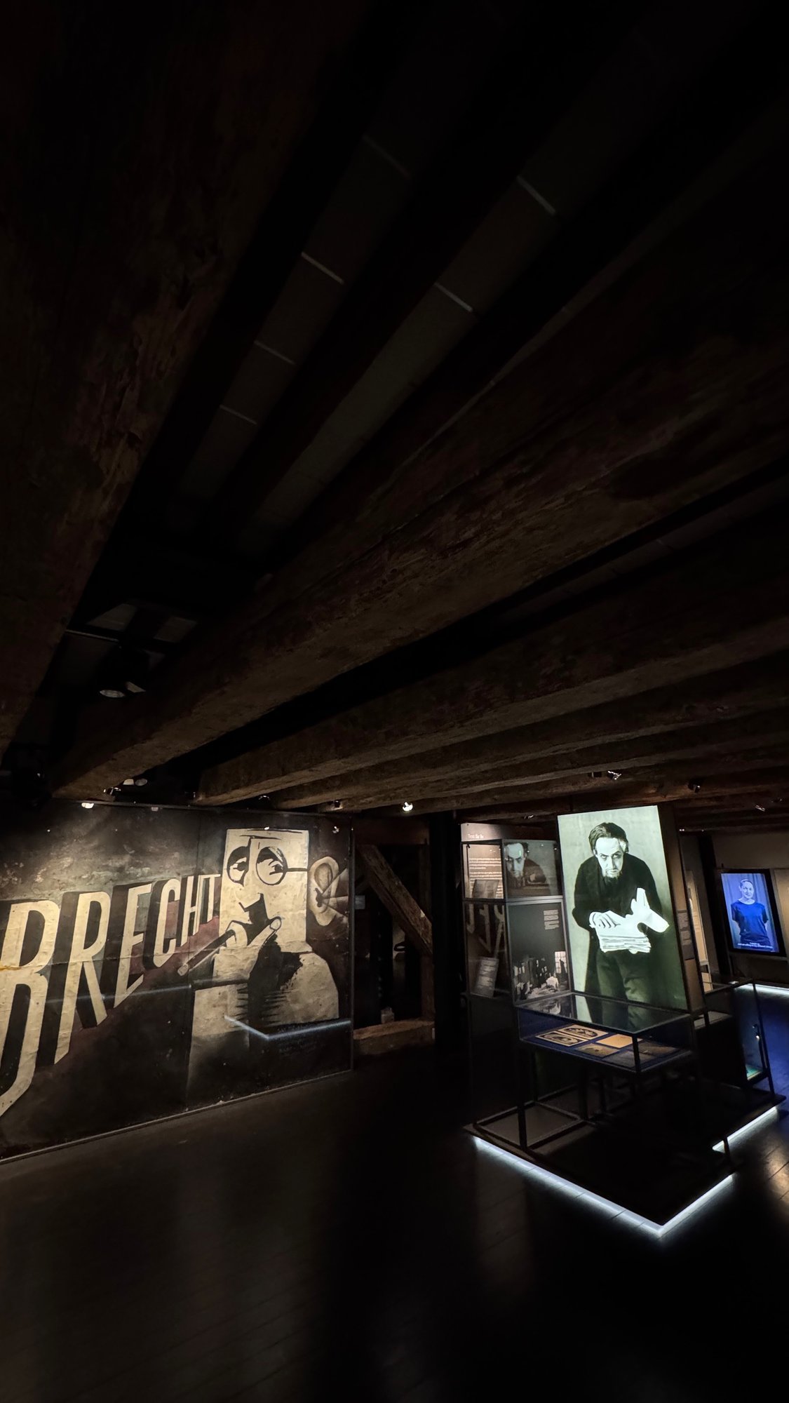 A large wall with the name Brecht and a photo display in the theater exhibition at Scenkonstmuseet.