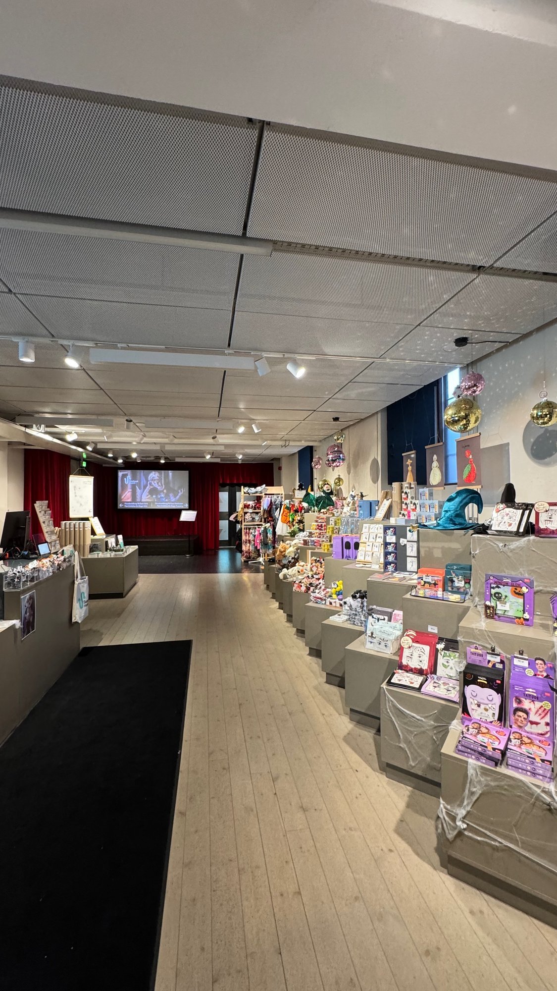 The museum shop at Scenkonstmuseet with tables of toys, books and gifts.