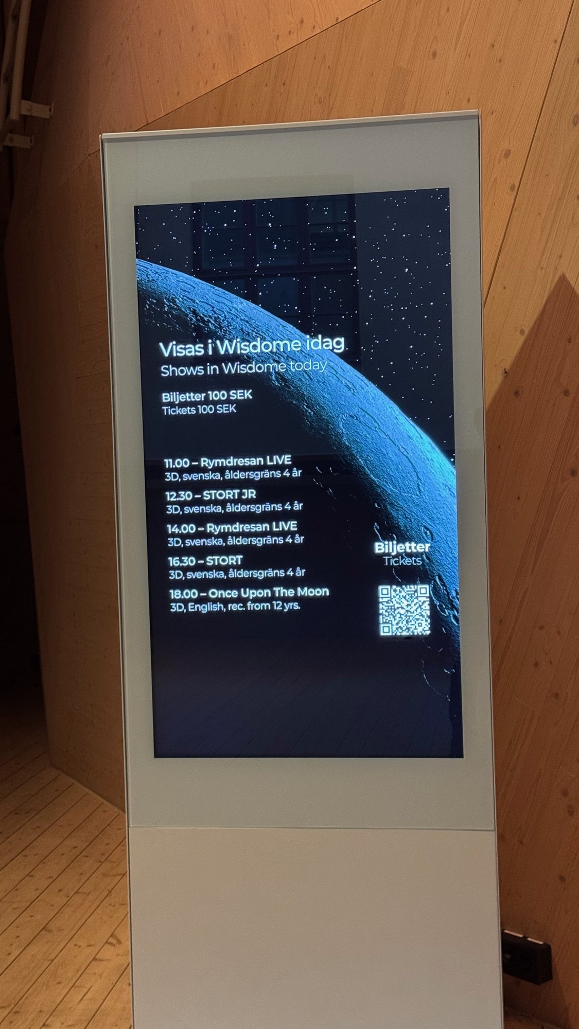A screen with the schedule of shows in Wisdome and the ticket price at Tekniska museet.