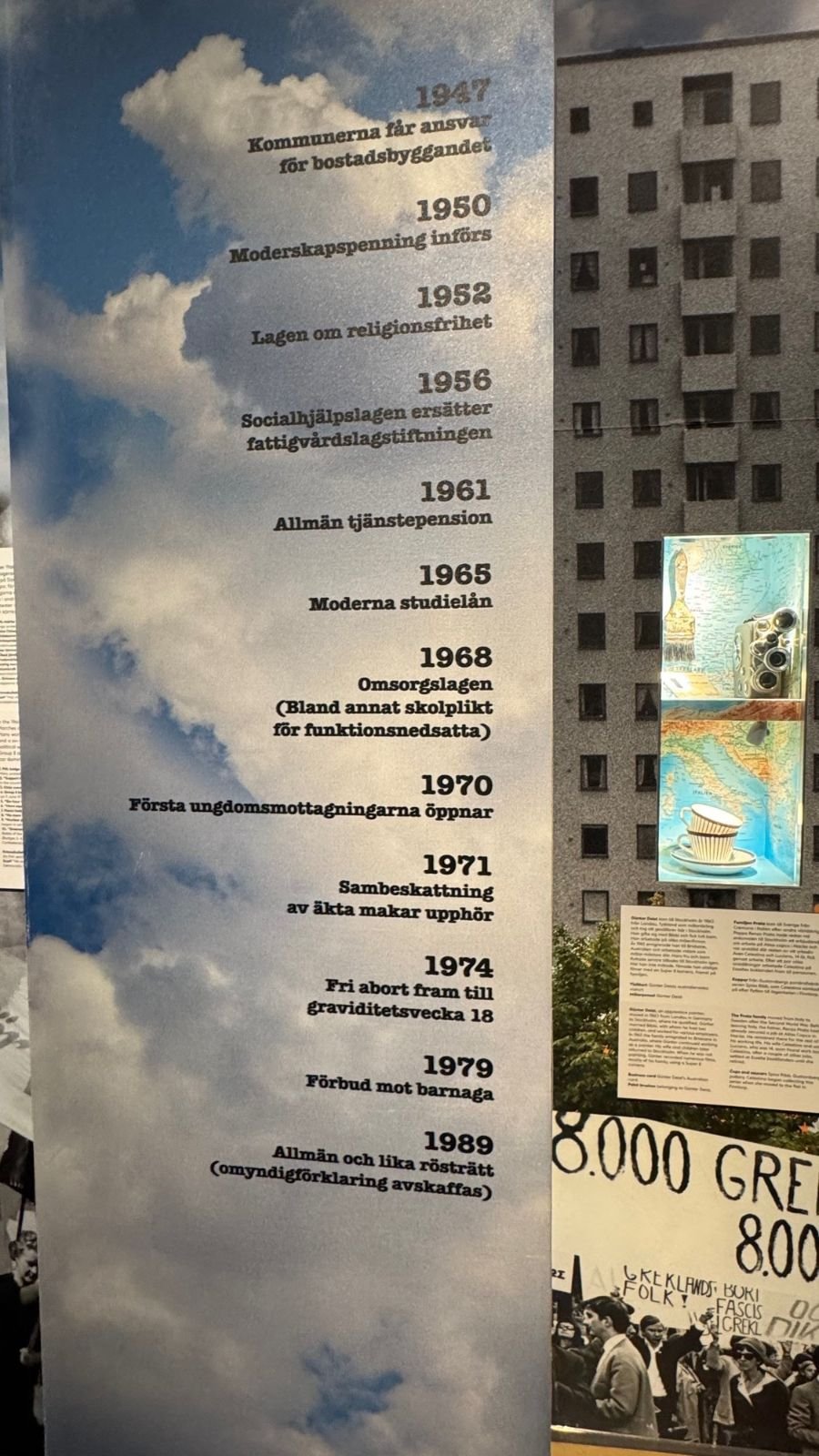 A timeline of Swedish social reforms from 1947 to 1989 printed on a sky with clouds at the Stockholm City Museum.