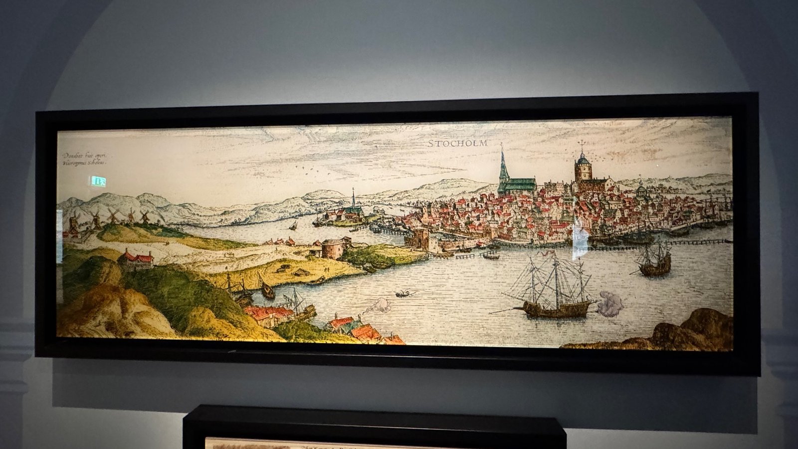 A framed hand-colored panorama of Stockholm with ships on the water at the Stockholm City Museum.