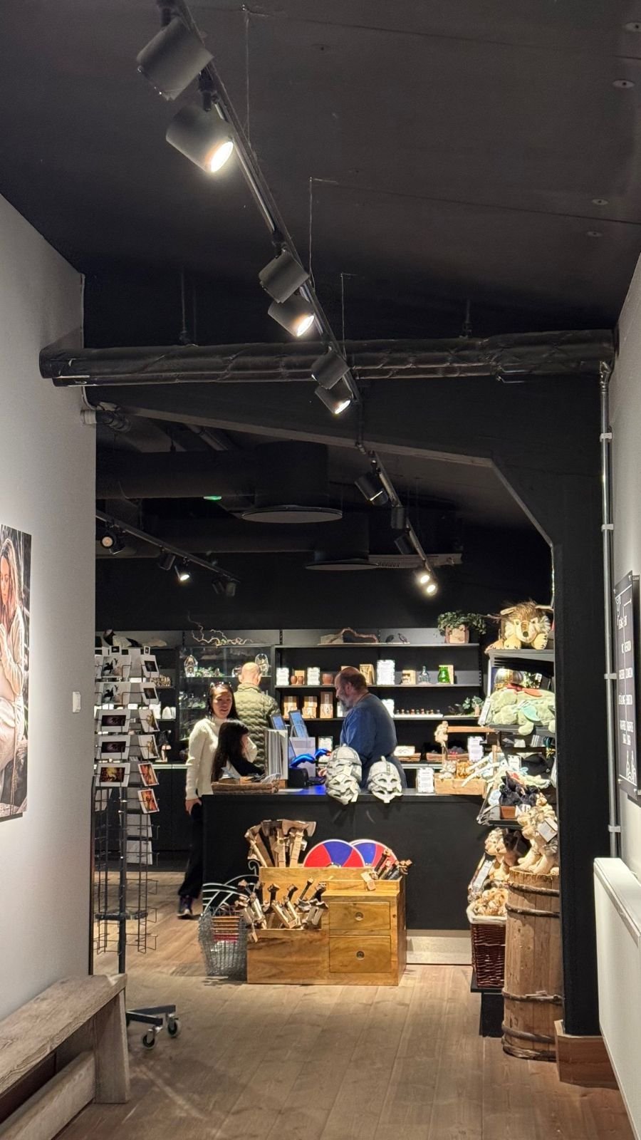 The museum shop at The Viking Museum with Viking helmets, toys, books and a wooden counter.