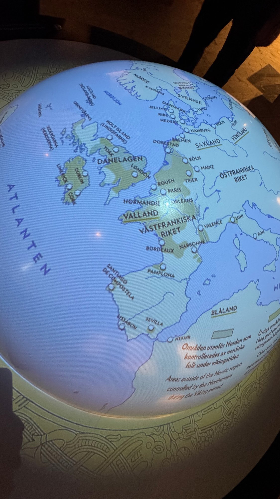 A lit globe shows a map of Viking Age Europe with Danelagen, Normandy and the Atlantic at The Viking Museum.