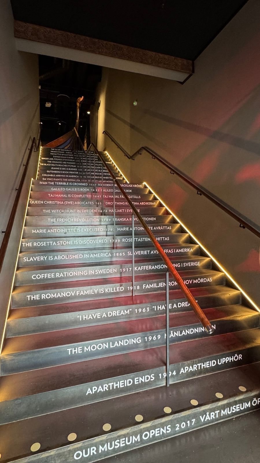 Lit stairs at The Viking Museum, with one date from world history printed on each step.