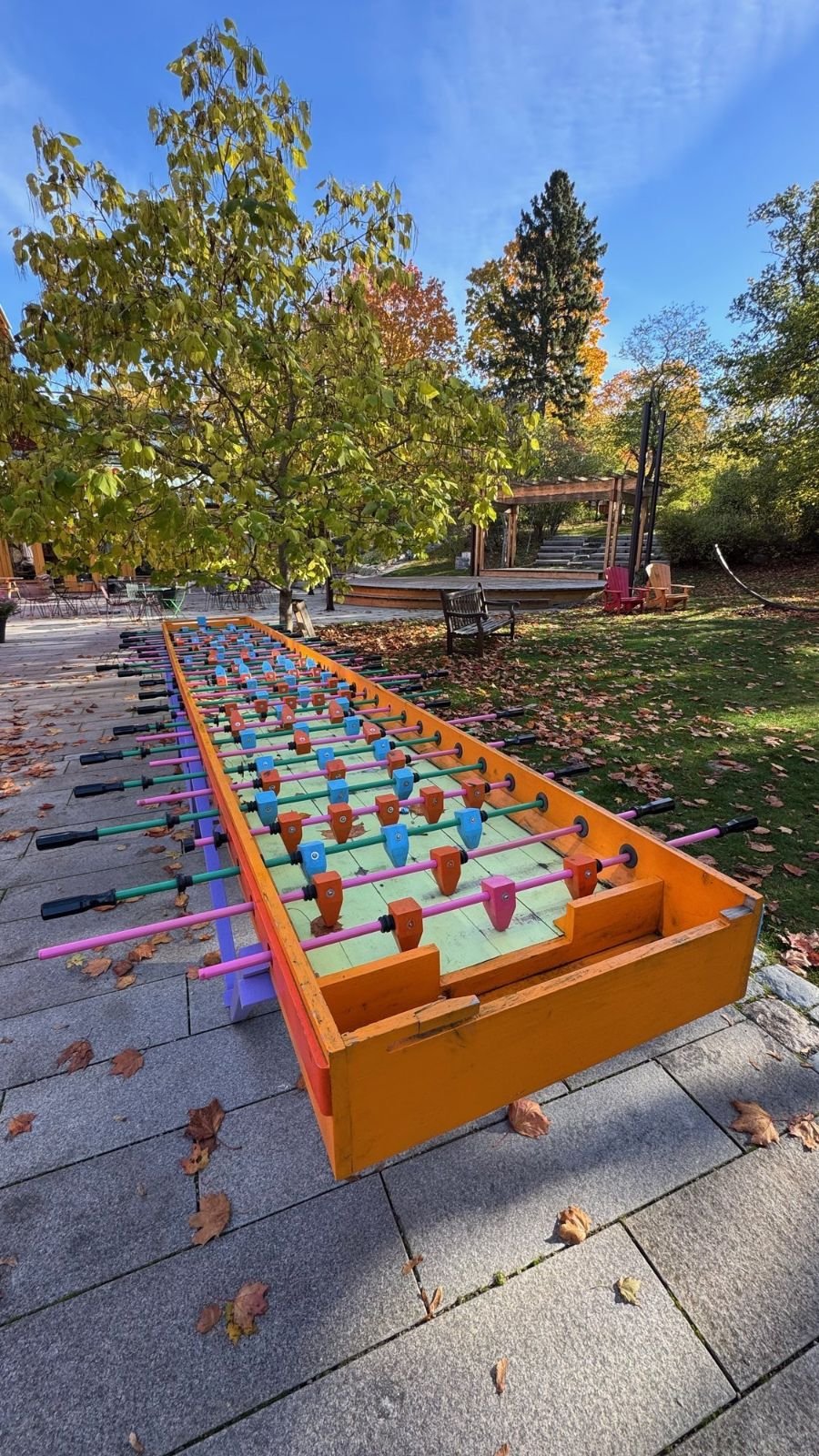 A very long orange foosball table on the stone terrace at Etnografiska museet.
