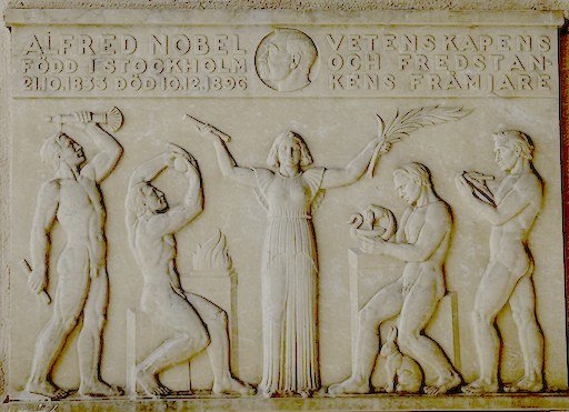 Stone relief of Alfred Nobel at Stockholm City Hall, inscribed with the words 'promoter of science and the idea of peace.'