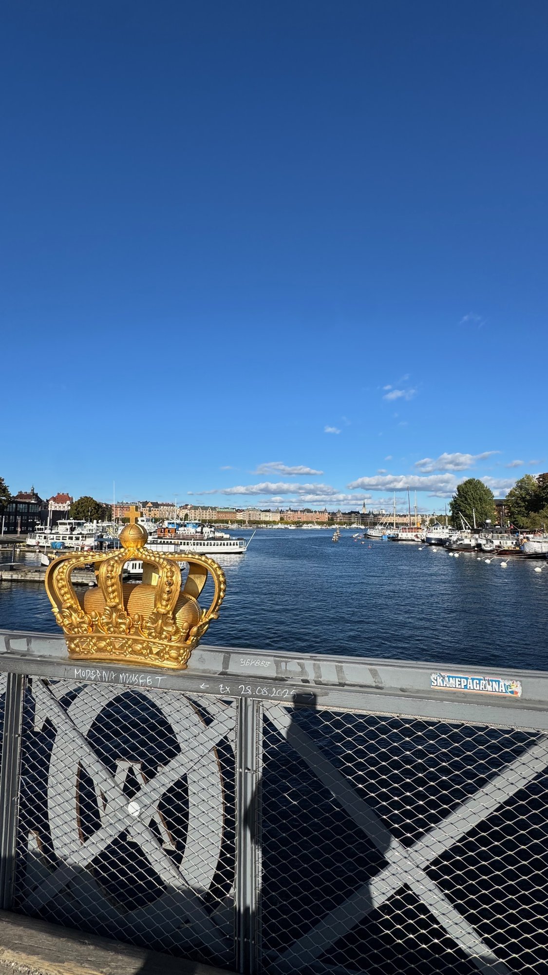 The golden crown on Skeppsholmsbron with the water behind it