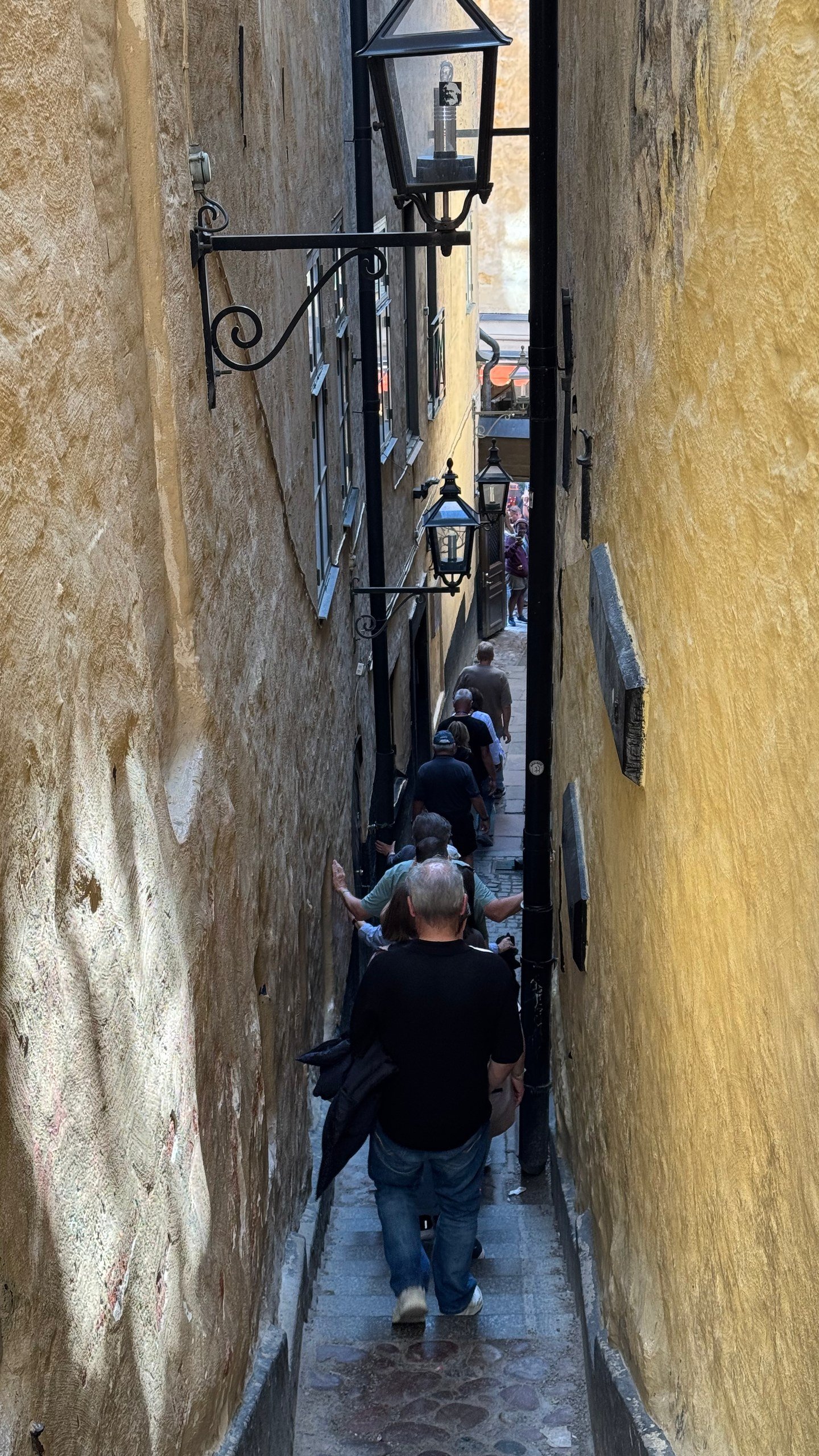 Visitors walk through M&auml;rten Trotzigs Gr&auml;nd, the narrowest alley in Gamla Stan, Stockholm's old town, photographed by Zayera Khan