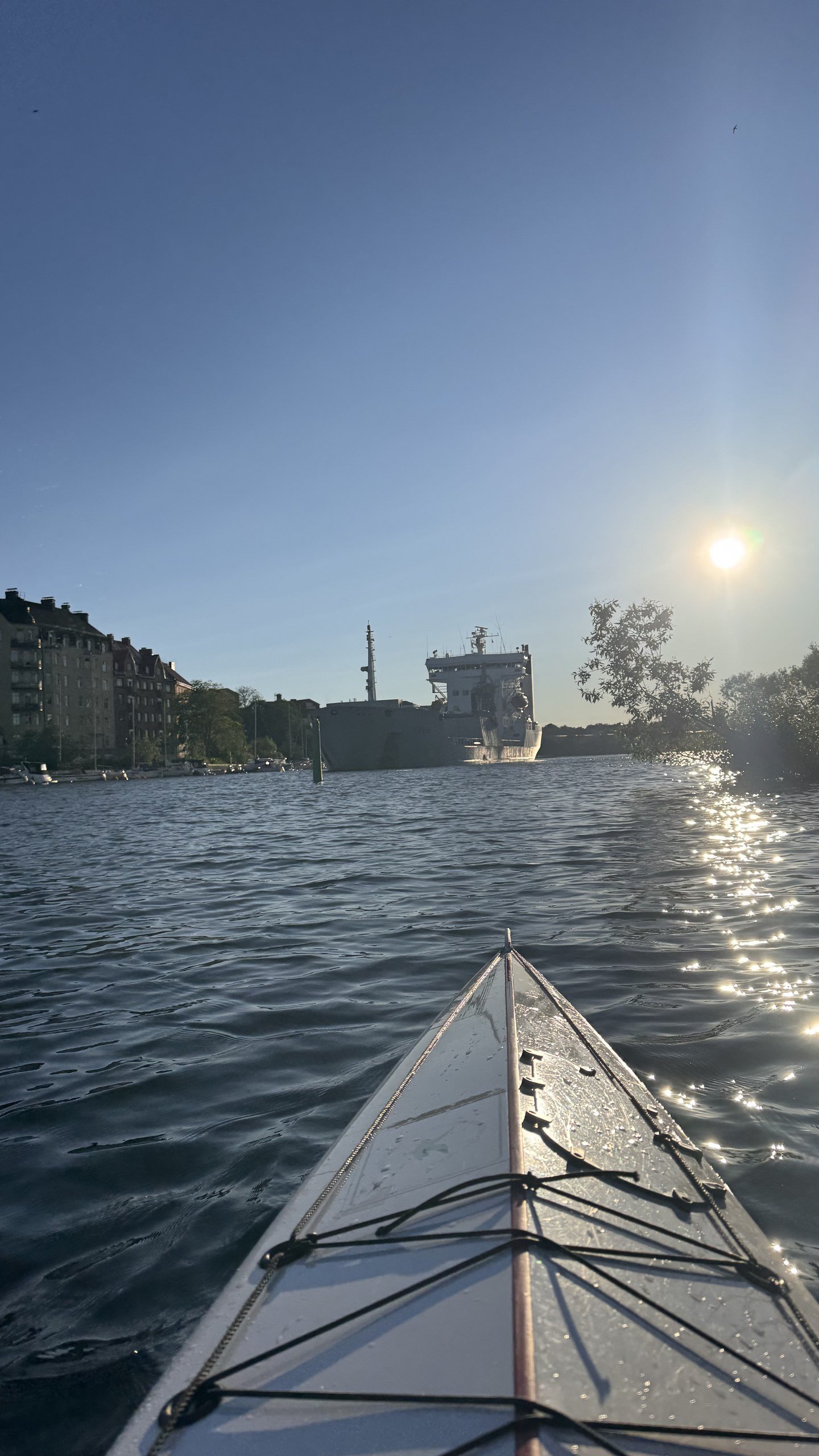 The sun sets over the water during a golden hour kayak trip in Stockholm, photographed by Zayera Khan