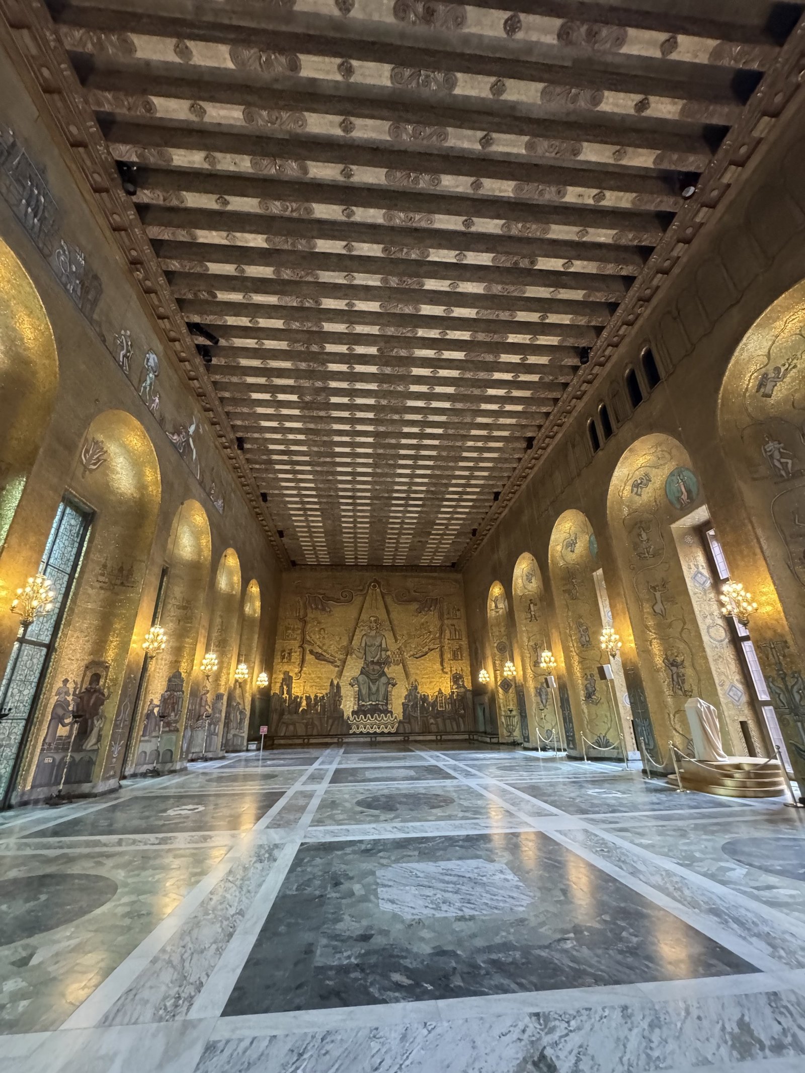 A wide view of the Golden Hall inside Stockholm City Hall, showing its gold mosaic walls. Photographed by Zayera Khan.