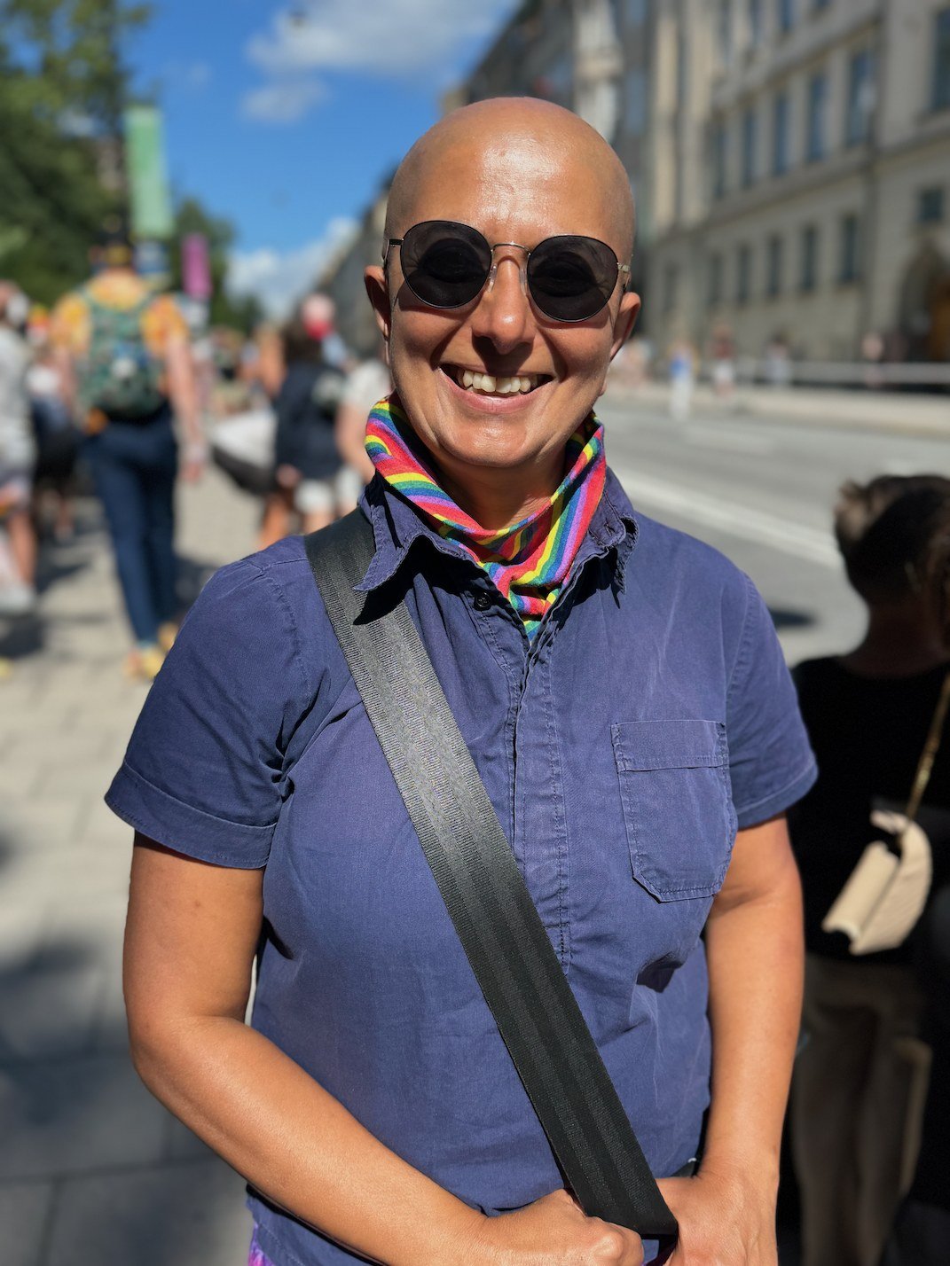 Zayera Khan walks through Stockholm wearing a rainbow scarf while leading a Pride-themed tour, photographed by Zayera Khan