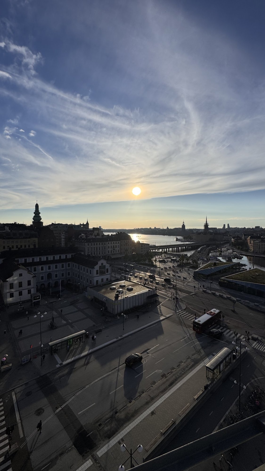 Slussen in Stockholm with red SL buses and Gamla stan at sunset