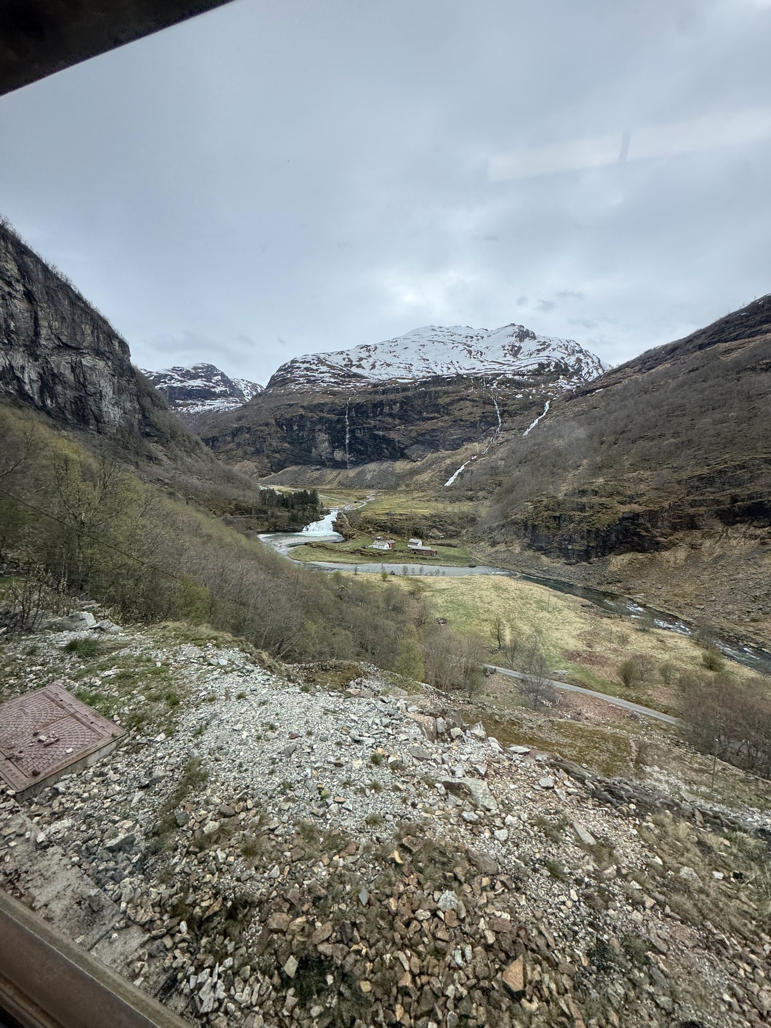 The Flåm valley with snow-topped mountains, seen from the Flåm Railway The Flåm valley with snow-topped mountains, seen from the Flåm Railway