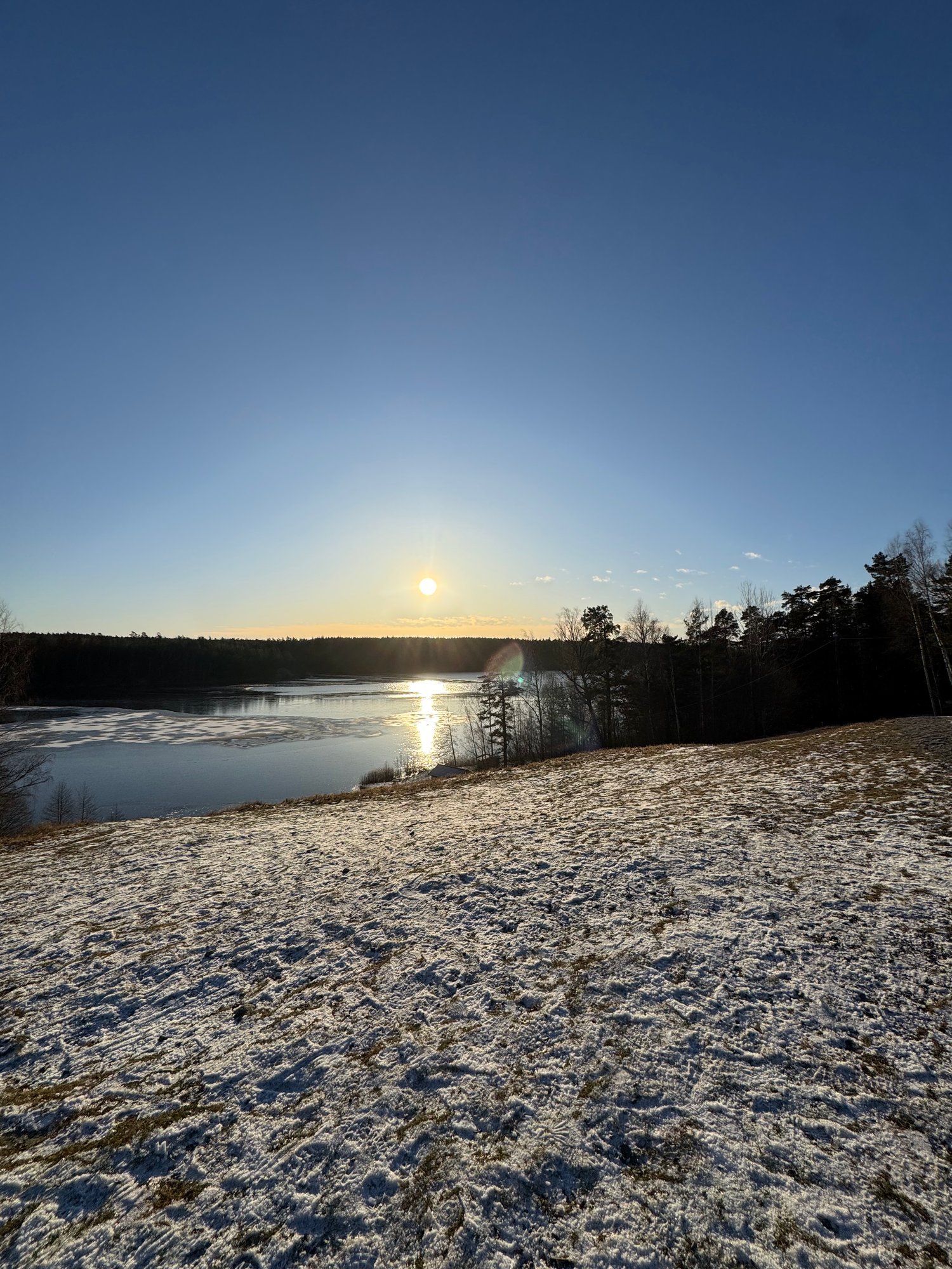 Sunset over a snowy lake near Stockholm
