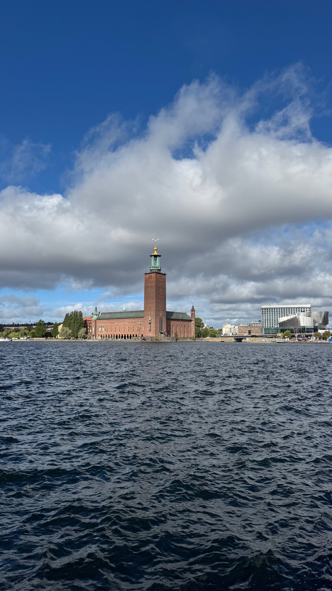 Stockholm City Hall seen from the water, with clouds over Riddarfjärden