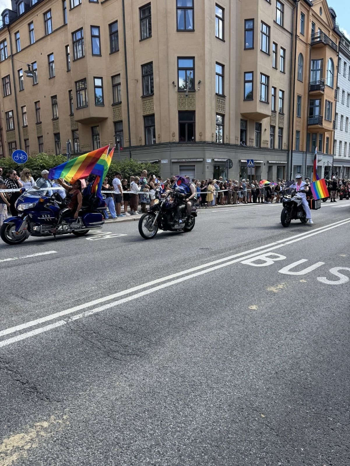 Motorcycle escort with rainbow flags at Stockholm Pride