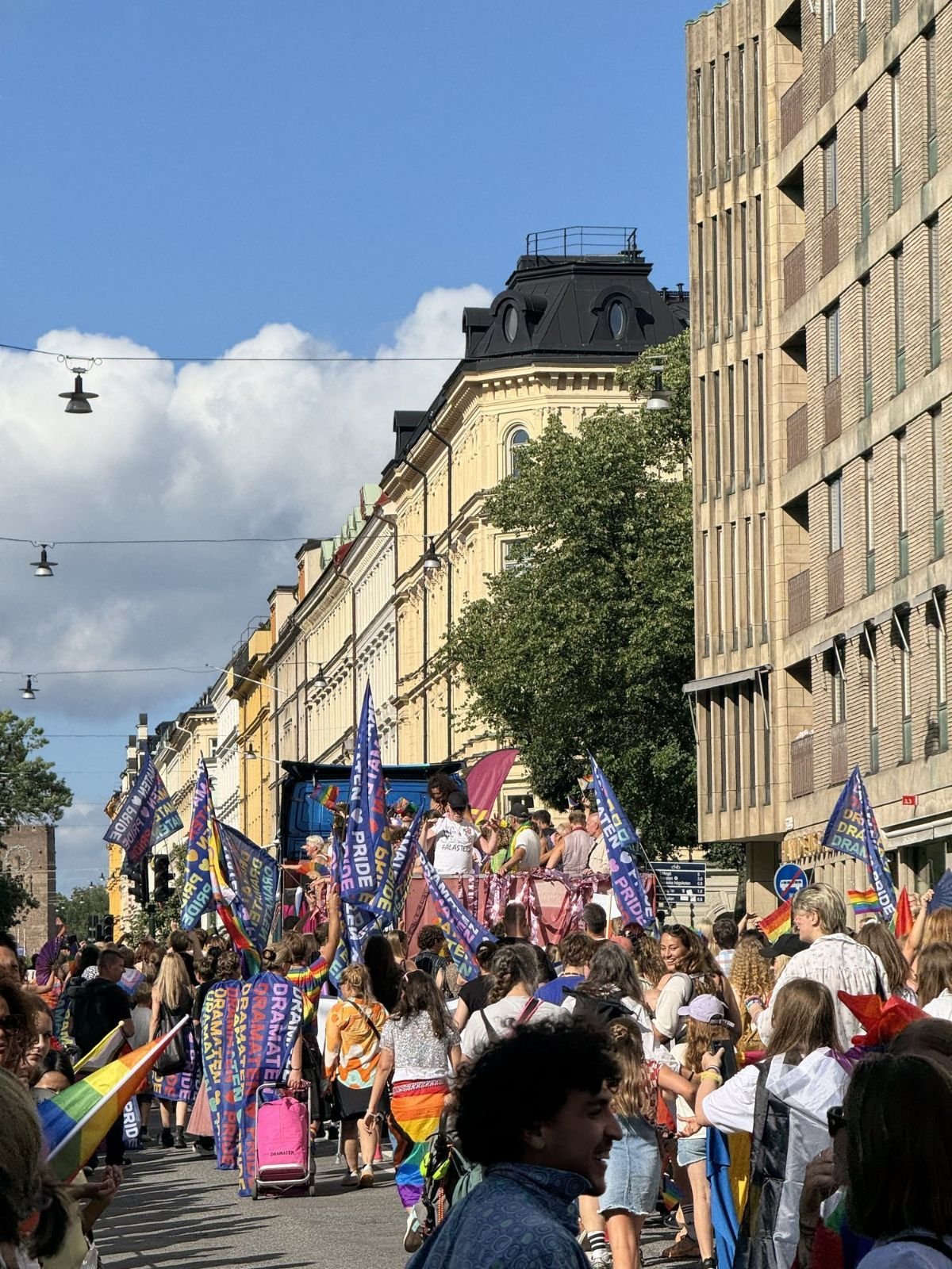 Pride parade banners in front of Stockholm architecture